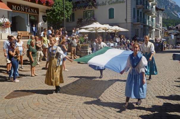 Ra bandiera ladina de r'Ulda portata da cuatro śoenetes: ra storia de agnere, da vive ancuoi, ves el doman.
