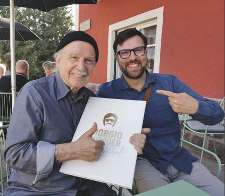 Giorgio Moroder cun l cumpusidëur Matthäus Crepaz, che à fat l aranjamënt dl medley per l zitadin d’unëur de Urtijëi.
